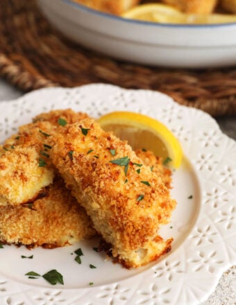 Fish sticks on plate with lemon wedges