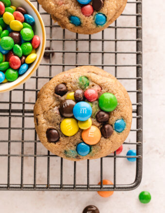 Overhead view of chocolate chip M&M cookies on wire rack