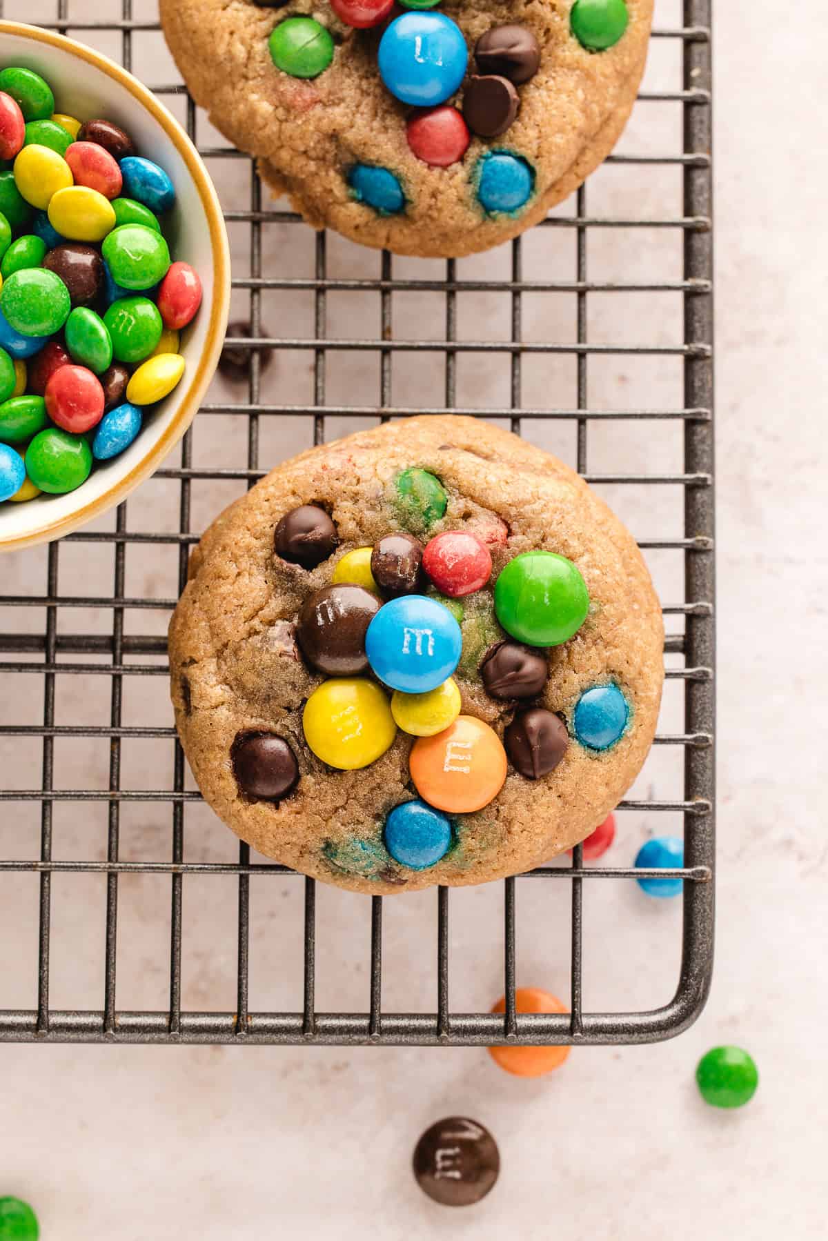 Overhead view of chocolate chip M&M cookies on wire rack