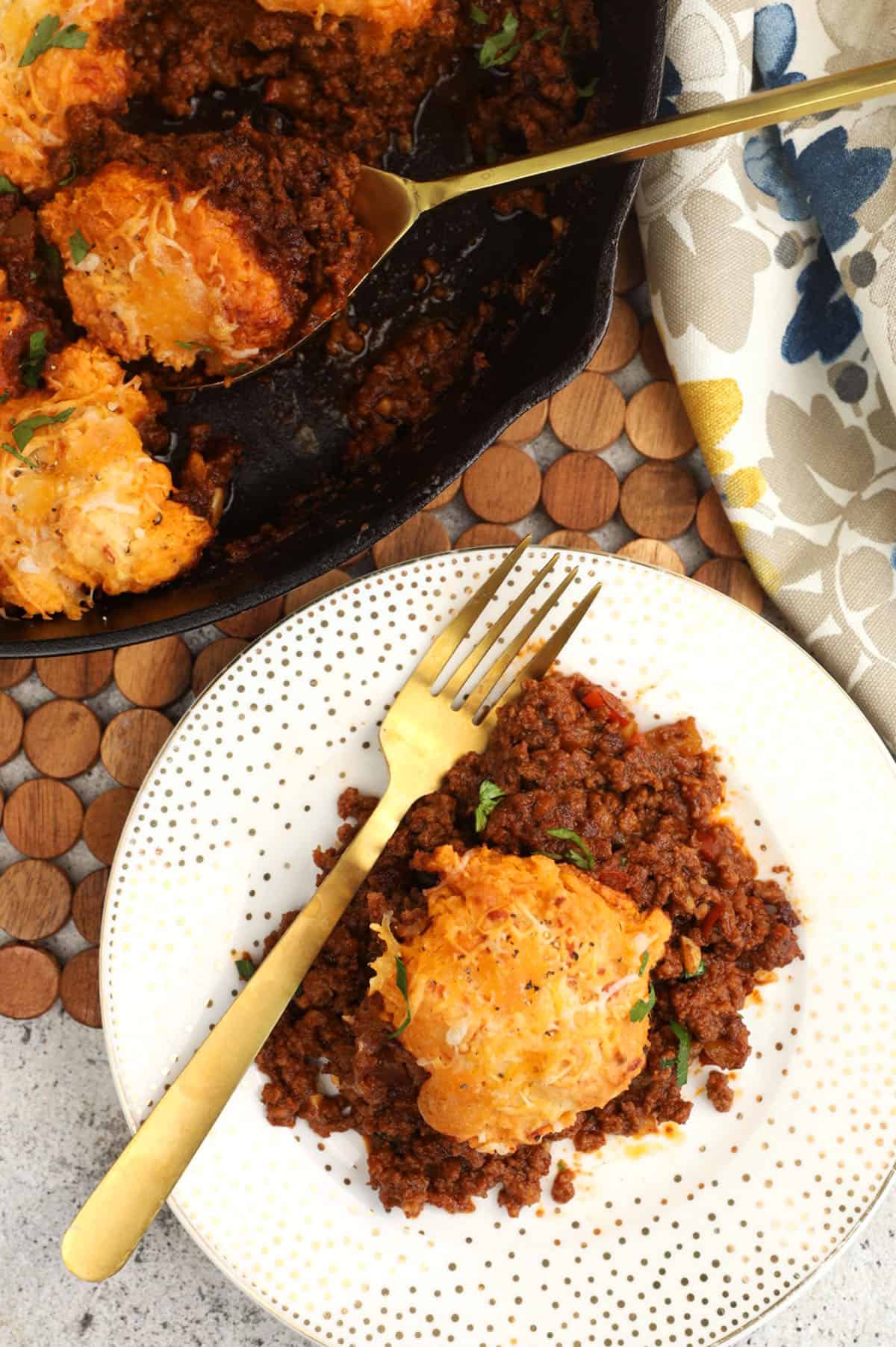 Overhead view of sloppy joe casserole on plate and in skillet