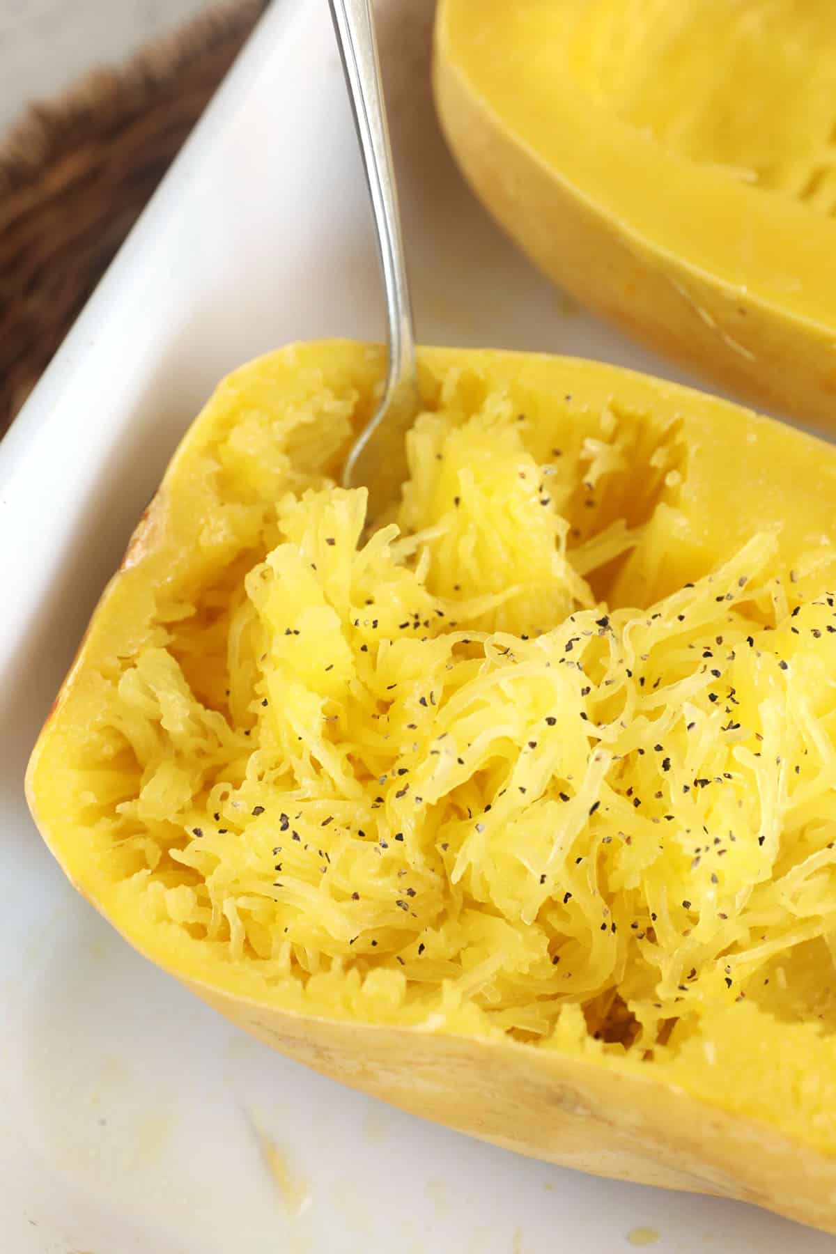 Cooked spaghetti squash in dish with fork