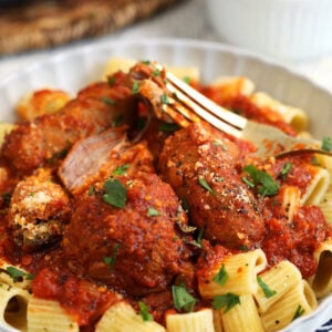 Sunday gravy served over bowl of pasta