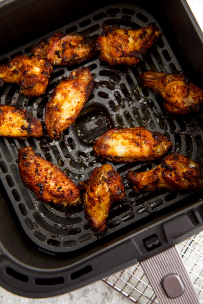 Cooked air fryer chicken wings in basket