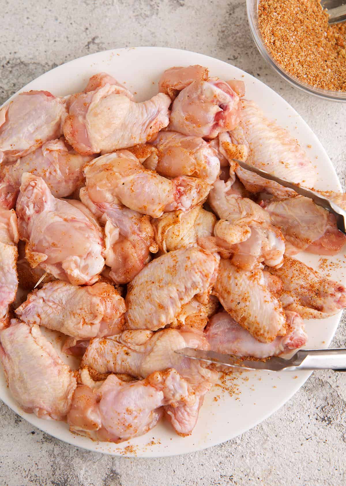 Uncooked chicken wings on plate