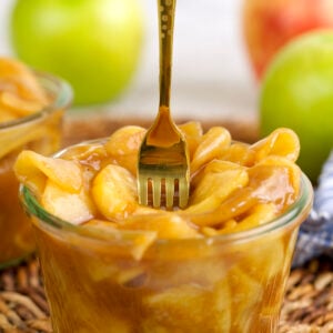 Fork sticking into jar of apple pie filling