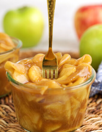 Fork sticking into jar of apple pie filling