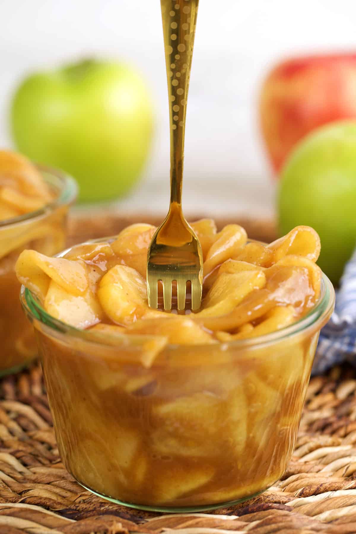 Fork sticking into jar of apple pie filling