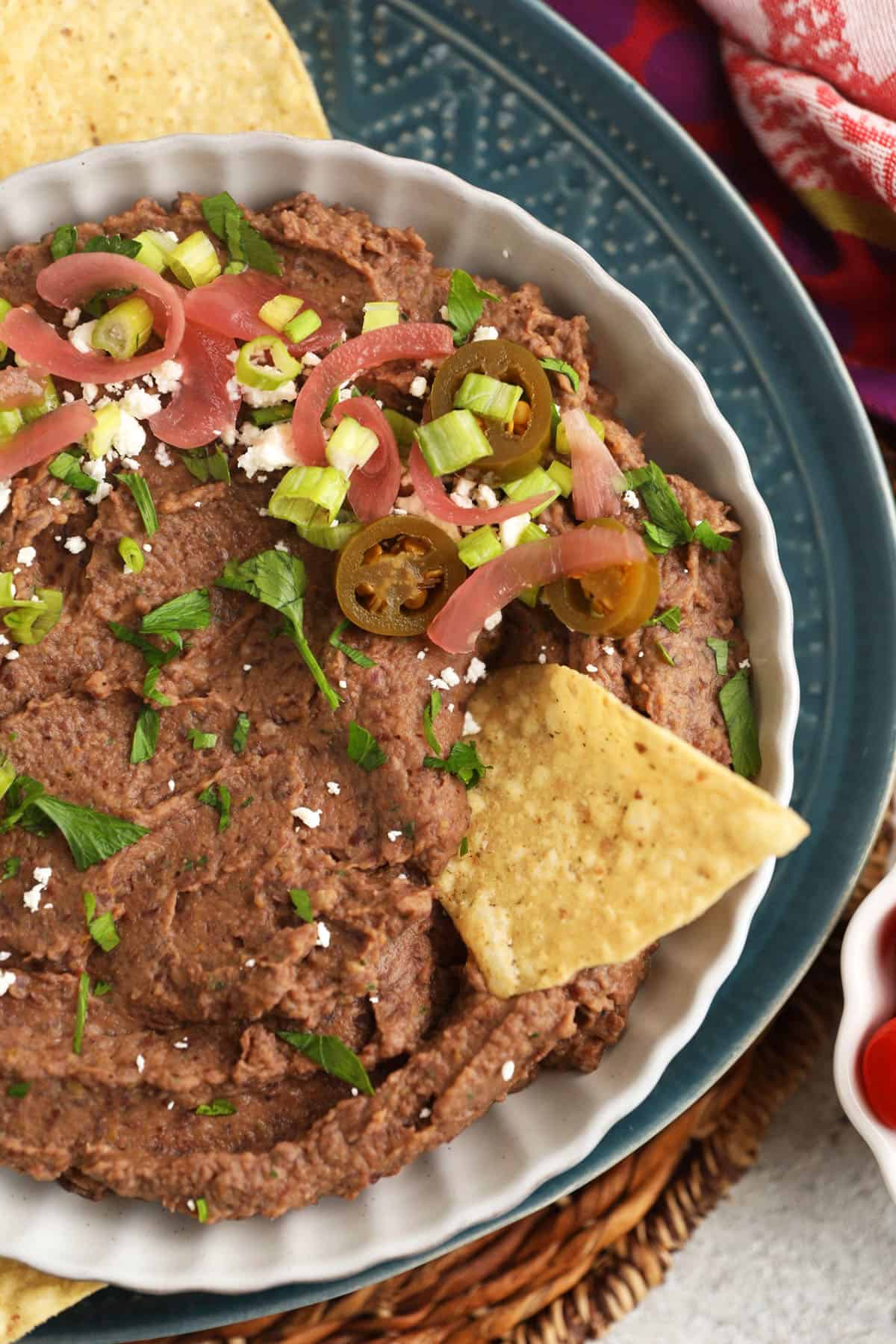 Black bean dip in bowl with tortilla chip