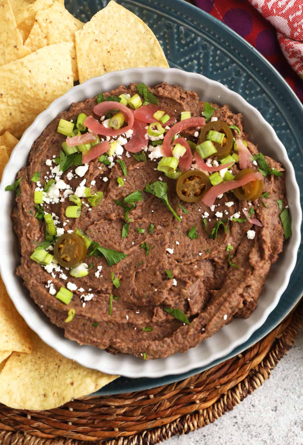 Black bean dip in bowl with tortilla chips