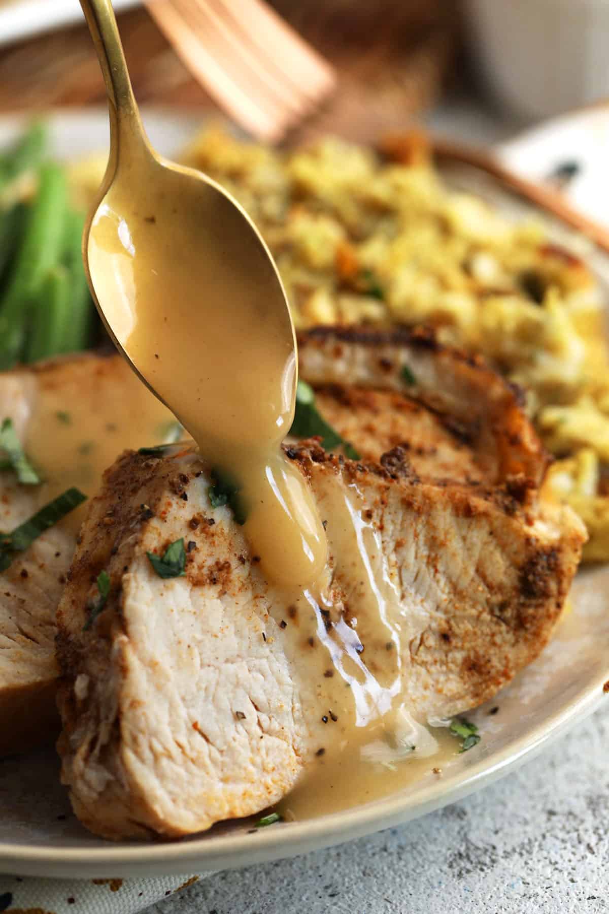 Drizzling gravy over Cajun blackened turkey breast