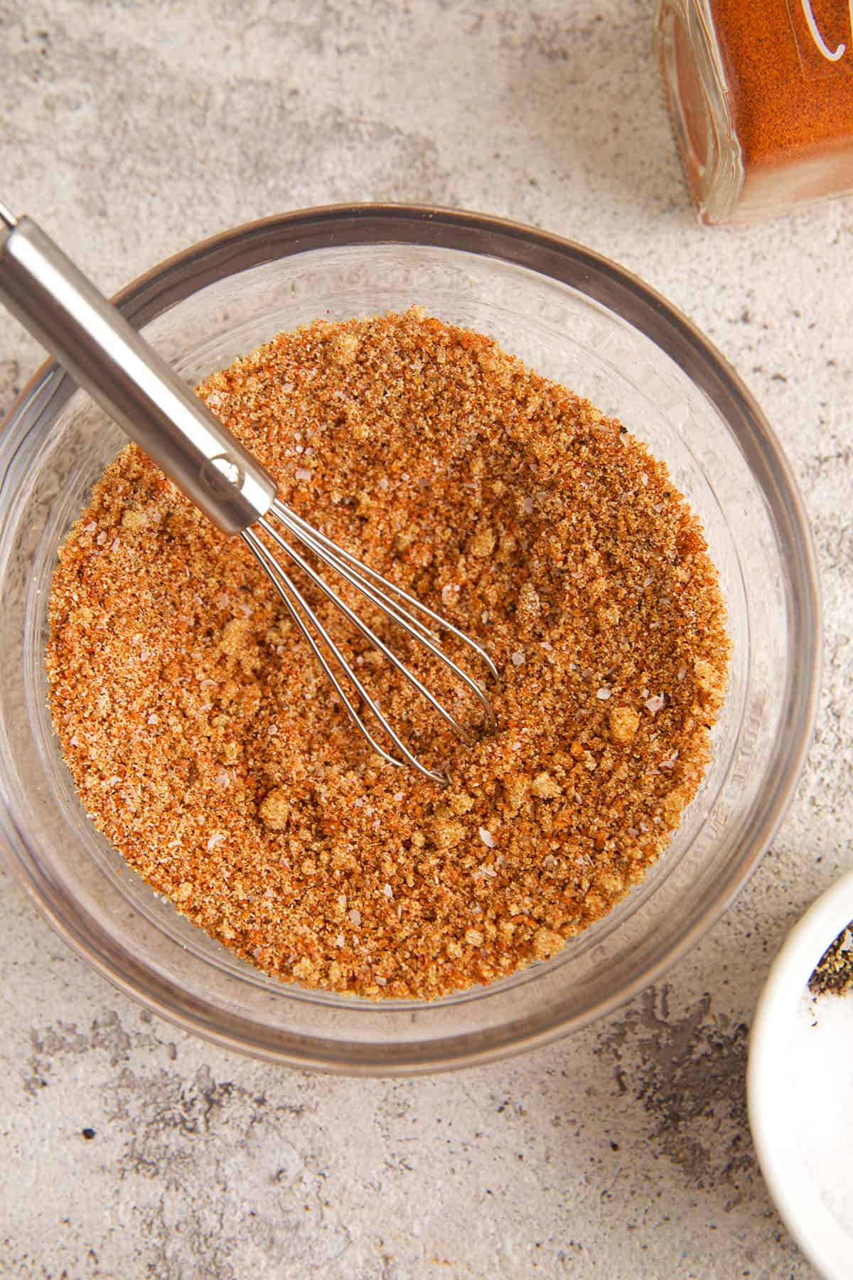 Chicken wing seasoning in bowl with whisk