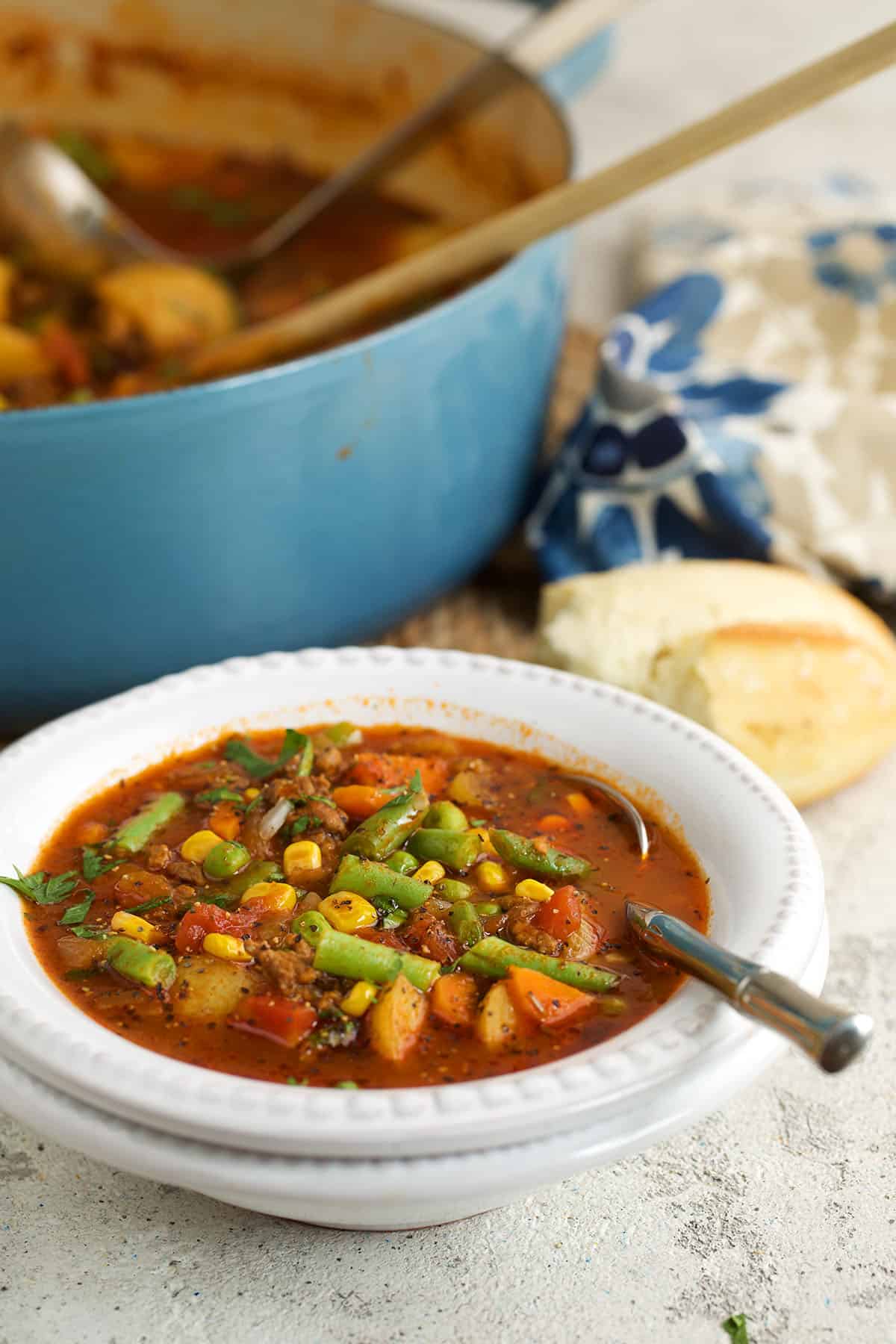 Hamburger soup in bowl with spoon