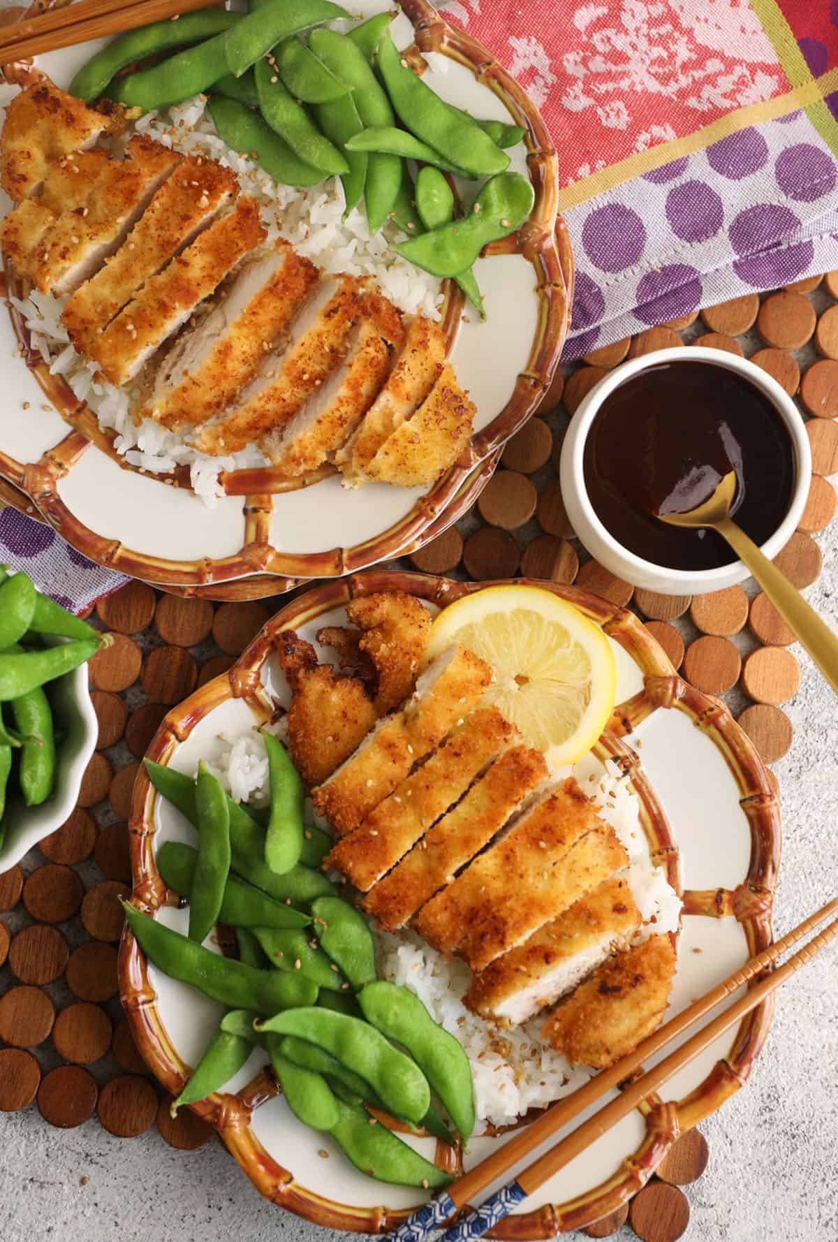 Overhead view of katsu chicken on 2 plates