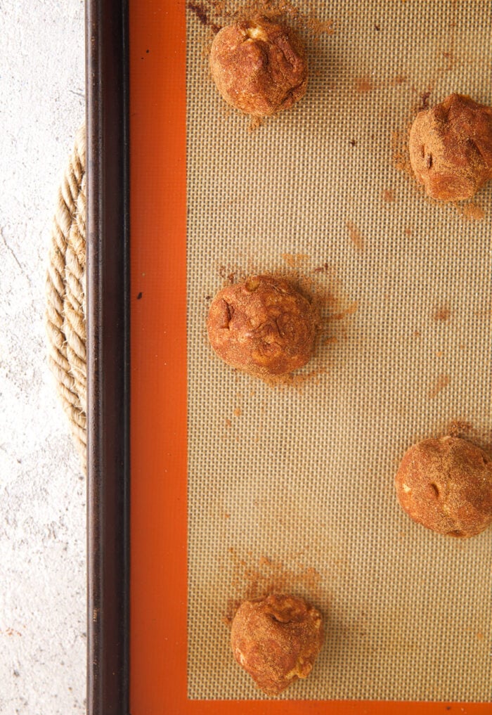 Balls of snickerdoodle dough on baking sheet