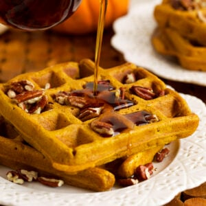 Pouring syrup onto pumpkin waffles