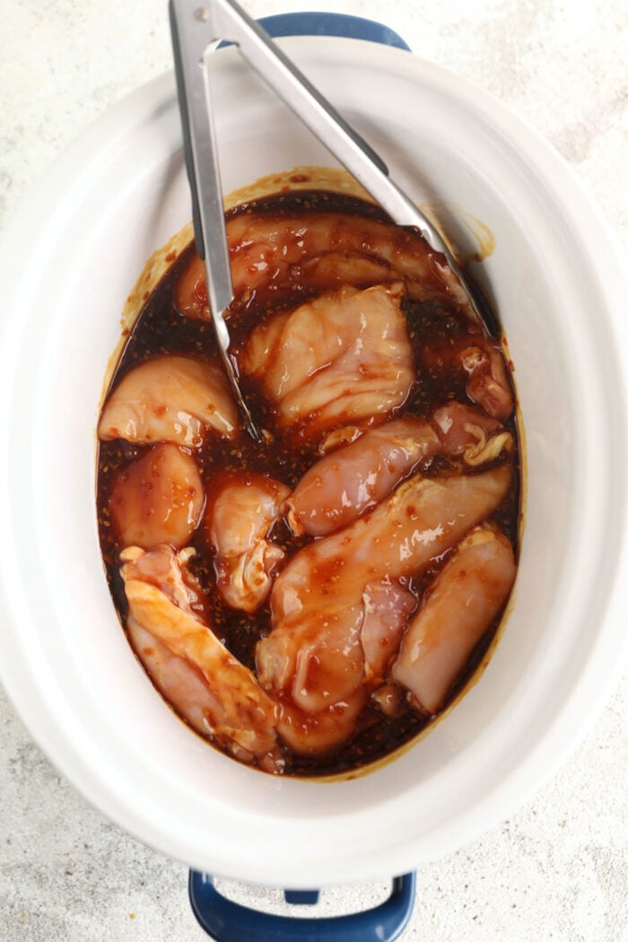 Chicken and teriyaki sauce in crockpot before cooking