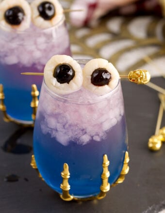 Witches brew cocktail with lychee eyeball garnish