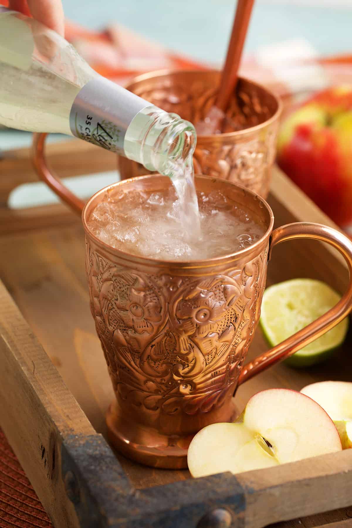 Pouring ginger beer into apple cider Moscow mule