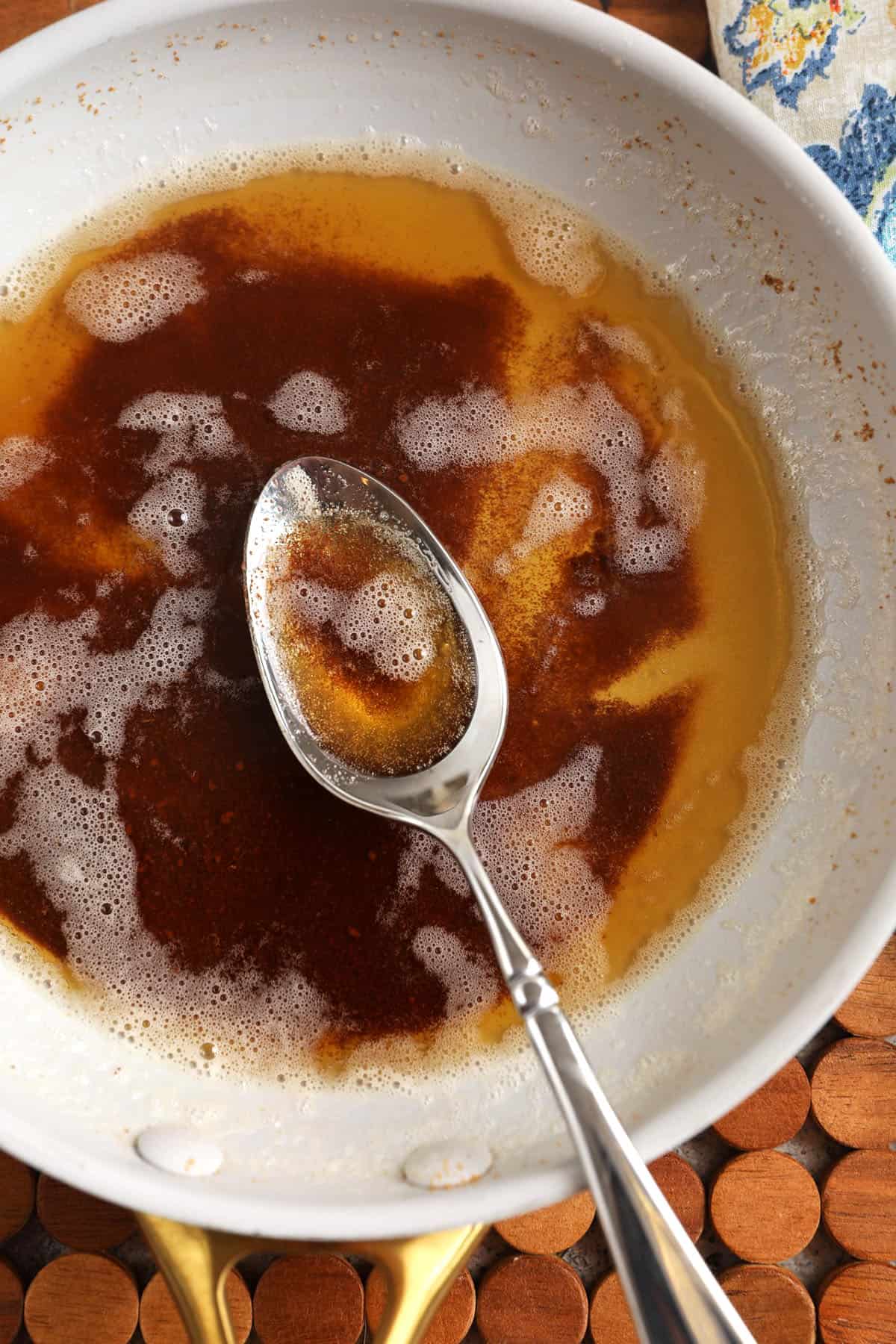 Brown butter in pan with spoon