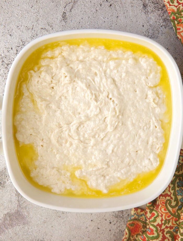 Dough for butter swim biscuits in pan of butter