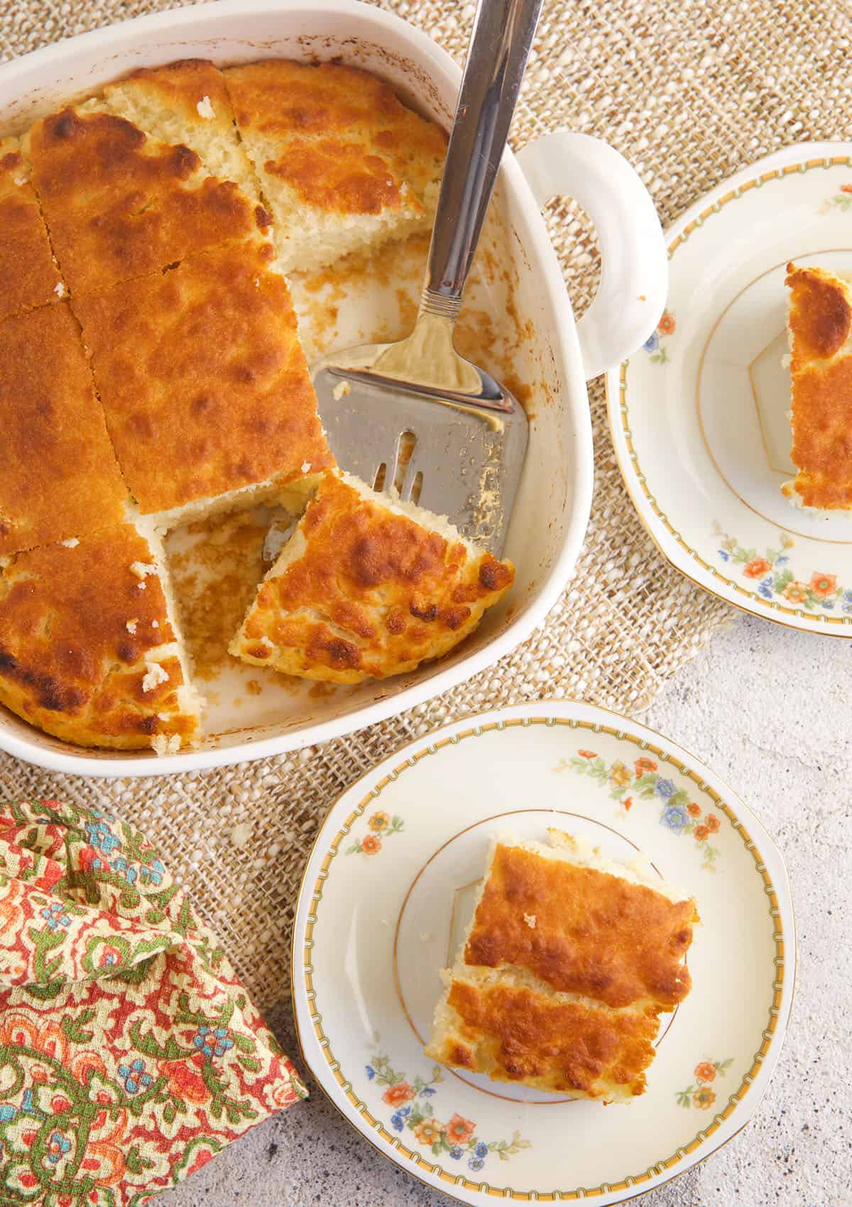 Overhead view of butter swim biscuits in baking dish and on plates