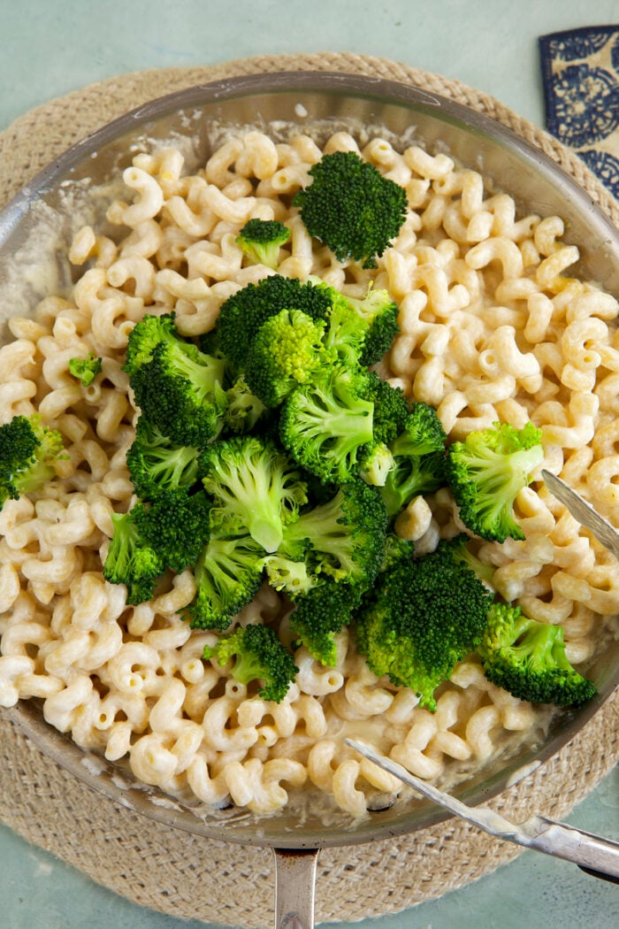 Broccoli added to pasta in skillet