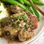 Chopped steak on plate with green beans