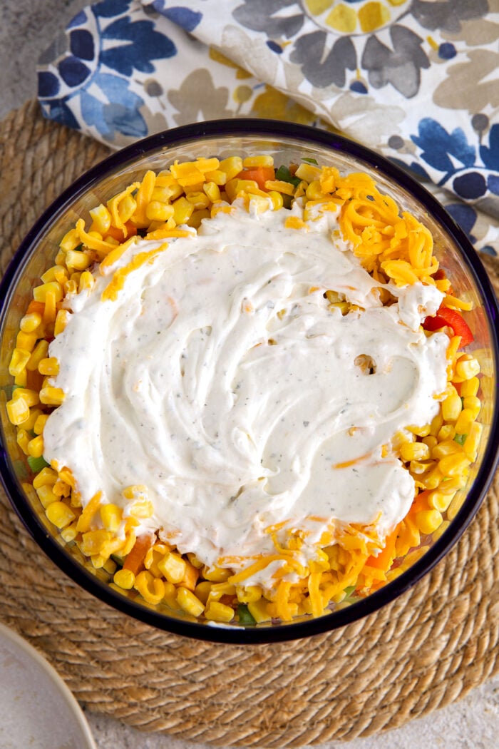 Overhead view of cornbread salad being assembled