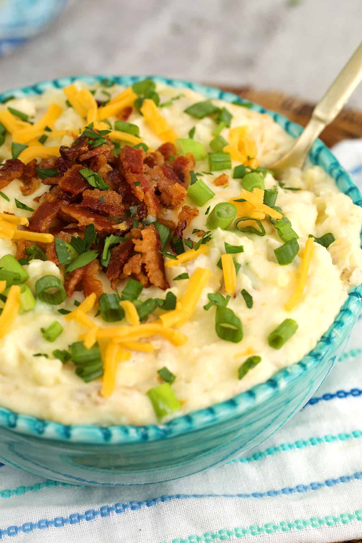 Bowl of loaded mashed potatoes with bacon and cheese