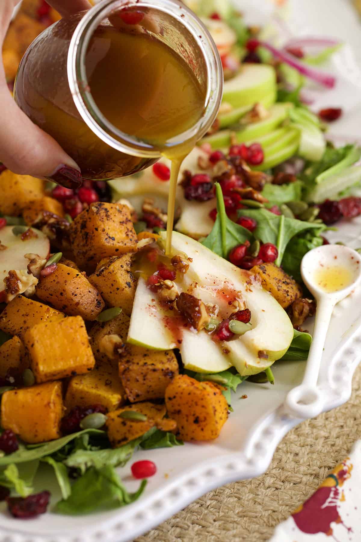 Pouring dressing onto Thanksgiving salad