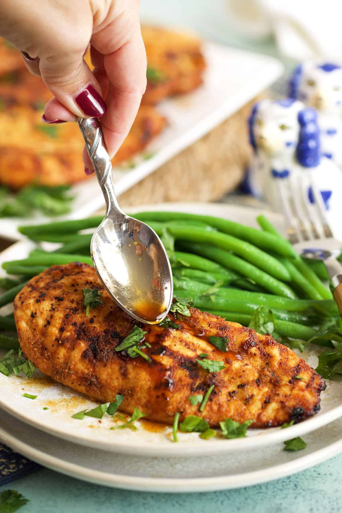 Drizzling sauce onto air fryer chicken breast