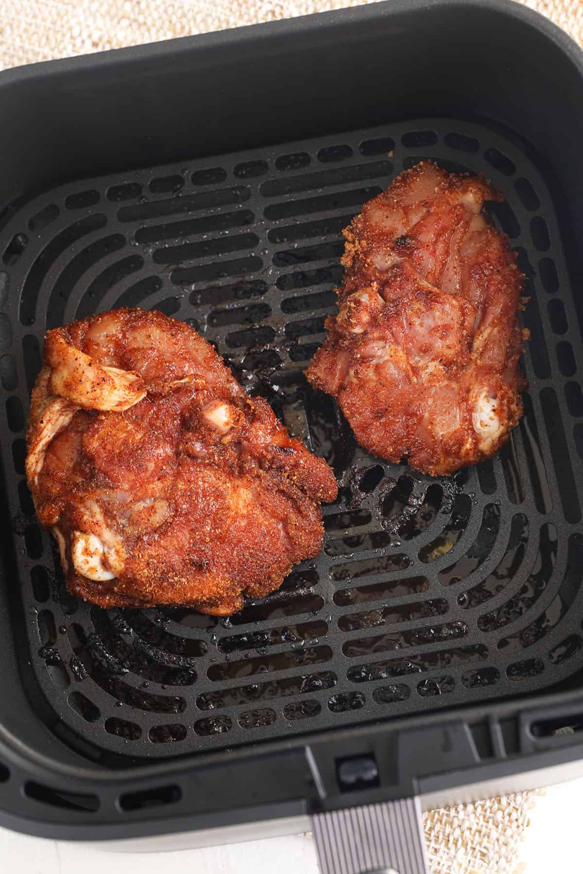 Chicken thighs in air fryer basket