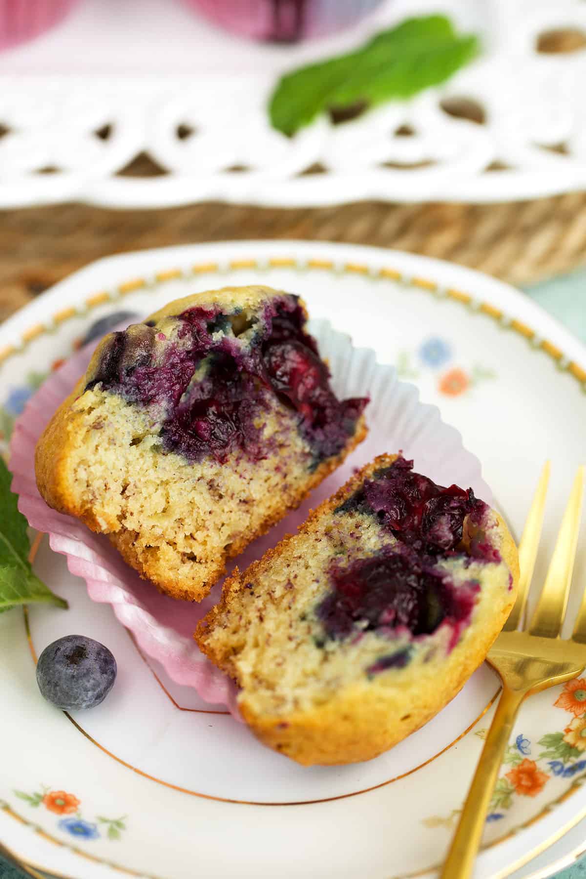 Halved banana blueberry muffin on plate