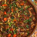 Overhead view of beef noodle soup in pot