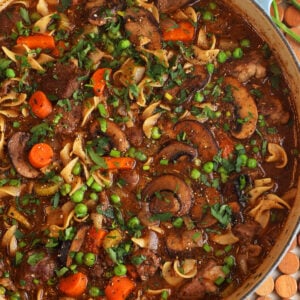 Overhead view of beef noodle soup in pot