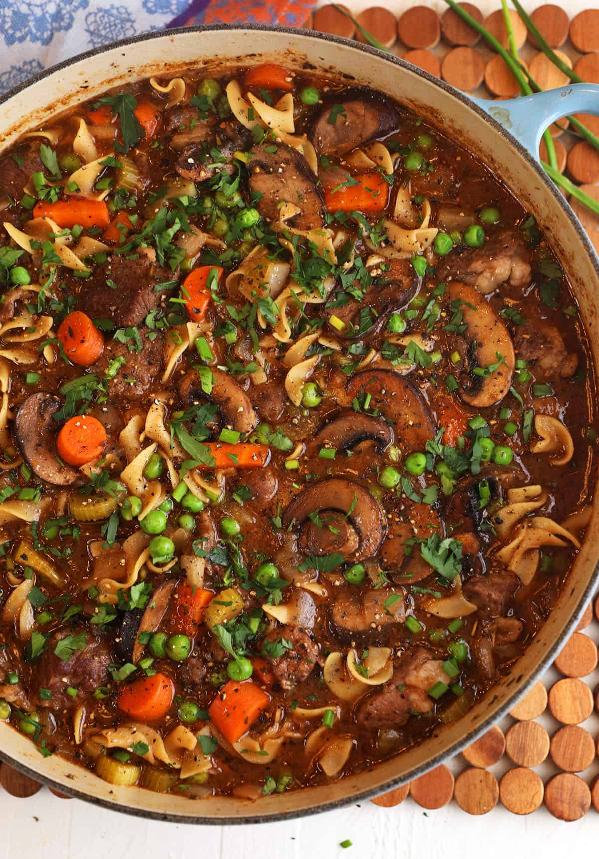 Overhead view of beef noodle soup in pot