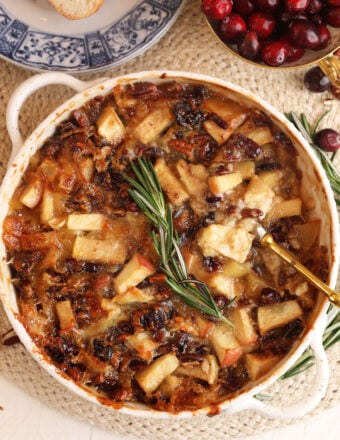 Overhead view of brown sugar baked brie dip with apples and cranberries