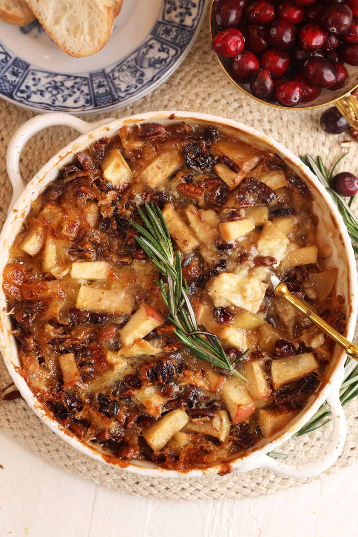 Overhead view of brown sugar baked brie dip with apples and cranberries