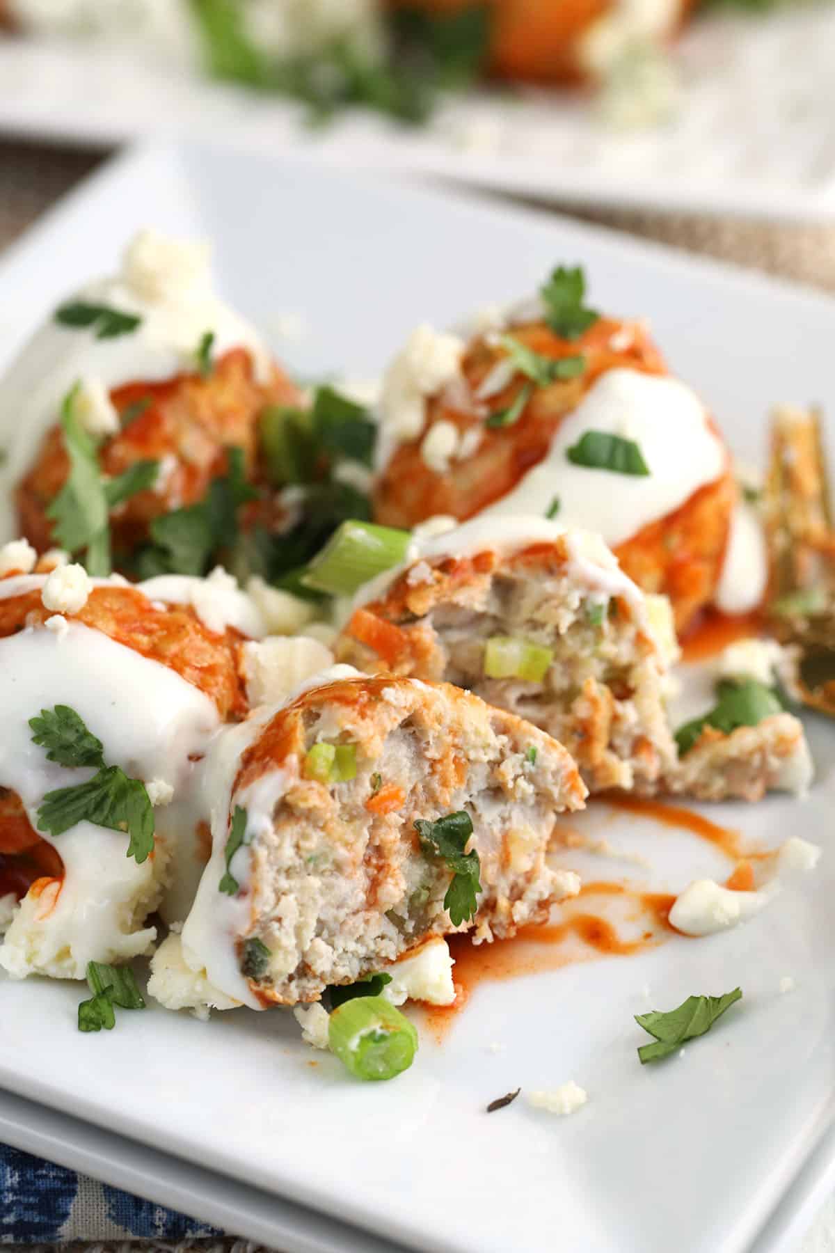 Buffalo chicken meatballs on serving platter with blue cheese dressing