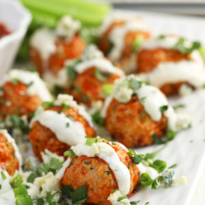 Buffalo chicken meatballs on tray with blue cheese dressing