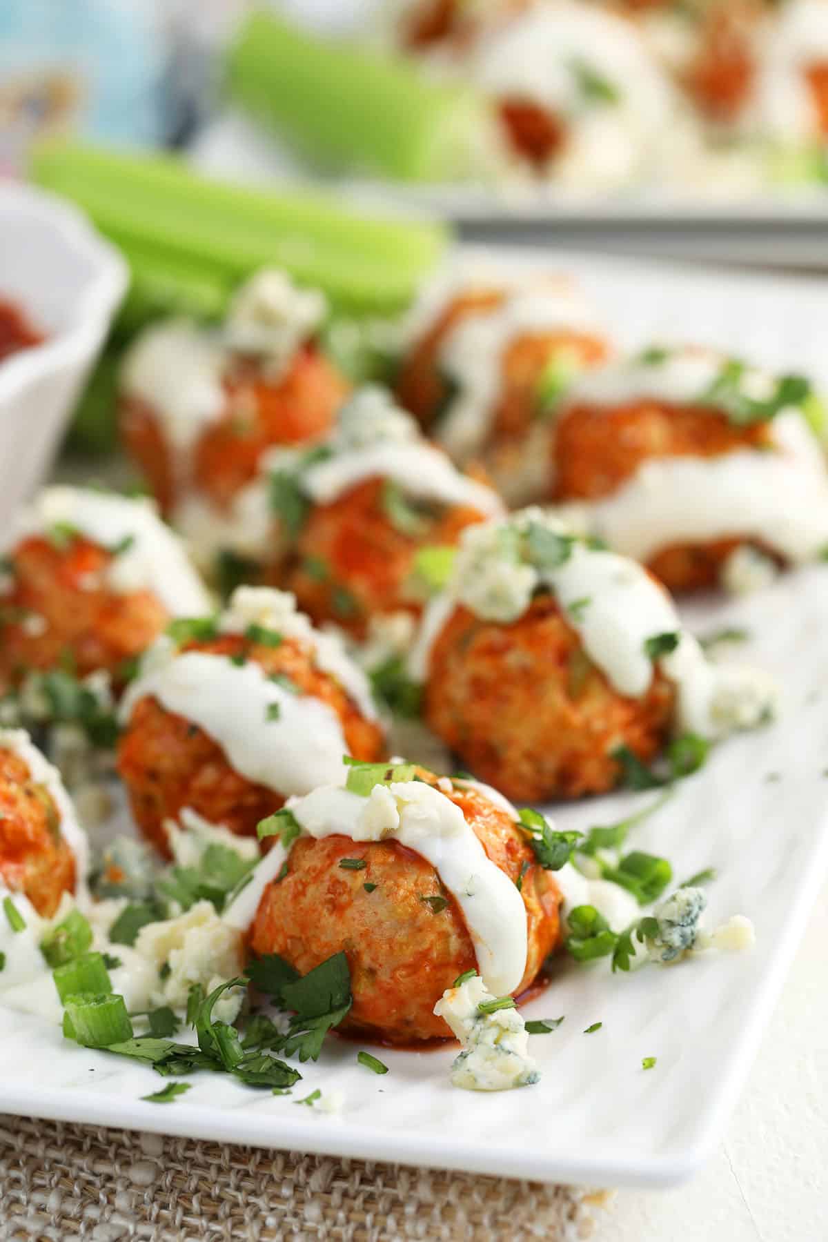 Buffalo chicken meatballs on tray with blue cheese dressing