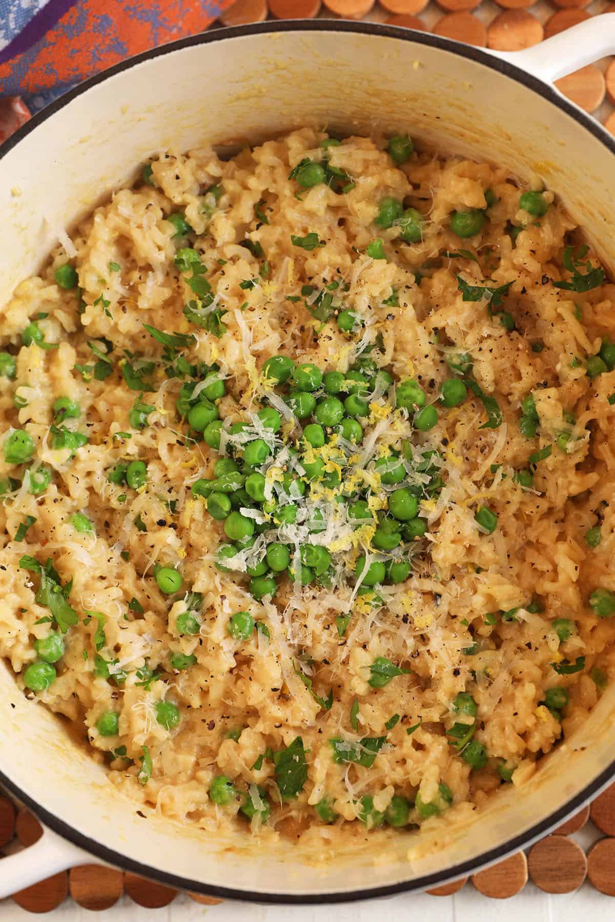 Overhead view of garlic Parmesan risotto with peas in Dutch oven