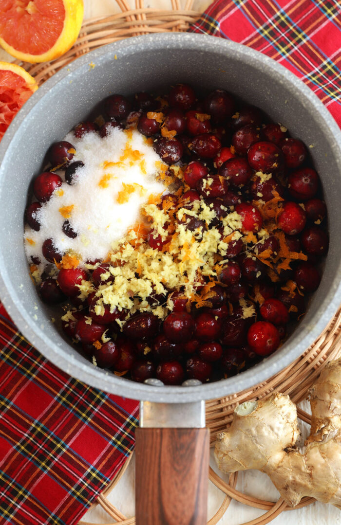 Ingredients for ginger cranberry jam in pot