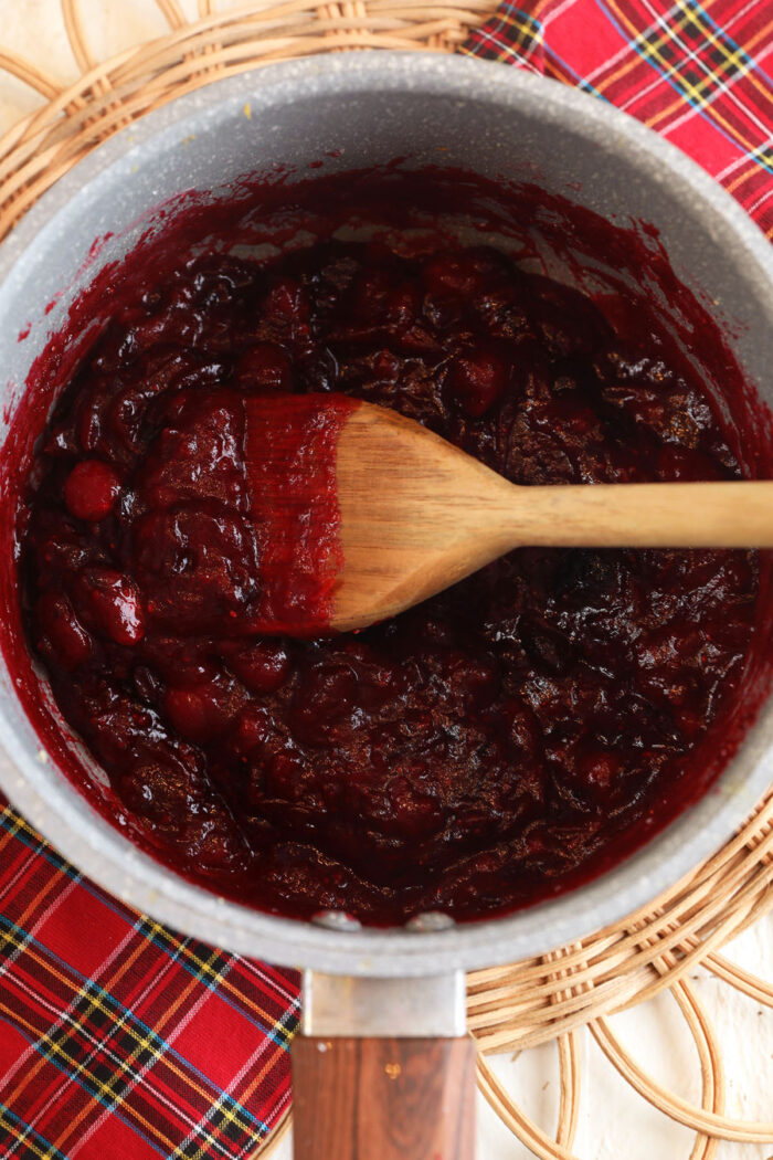 Ginger cranberry jam cooking in pot