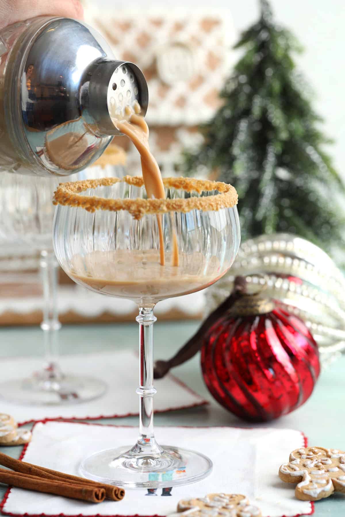 Pouring gingerbread martini into glass