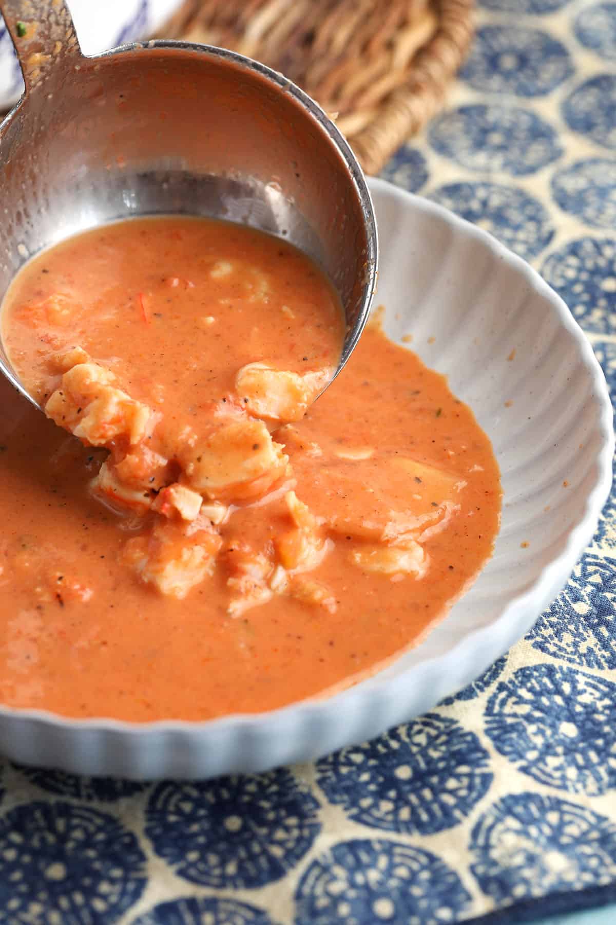 Ladling shrimp bisque into bowl