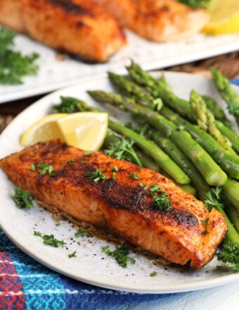 Crispy air fryer salmon on plate with asparagus