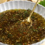 Bowl of Italian bread dipping oil with spoon