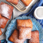 Overhead view of homemade beignets on plate