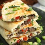 Philly cheesesteak quesadilla stacked on plate